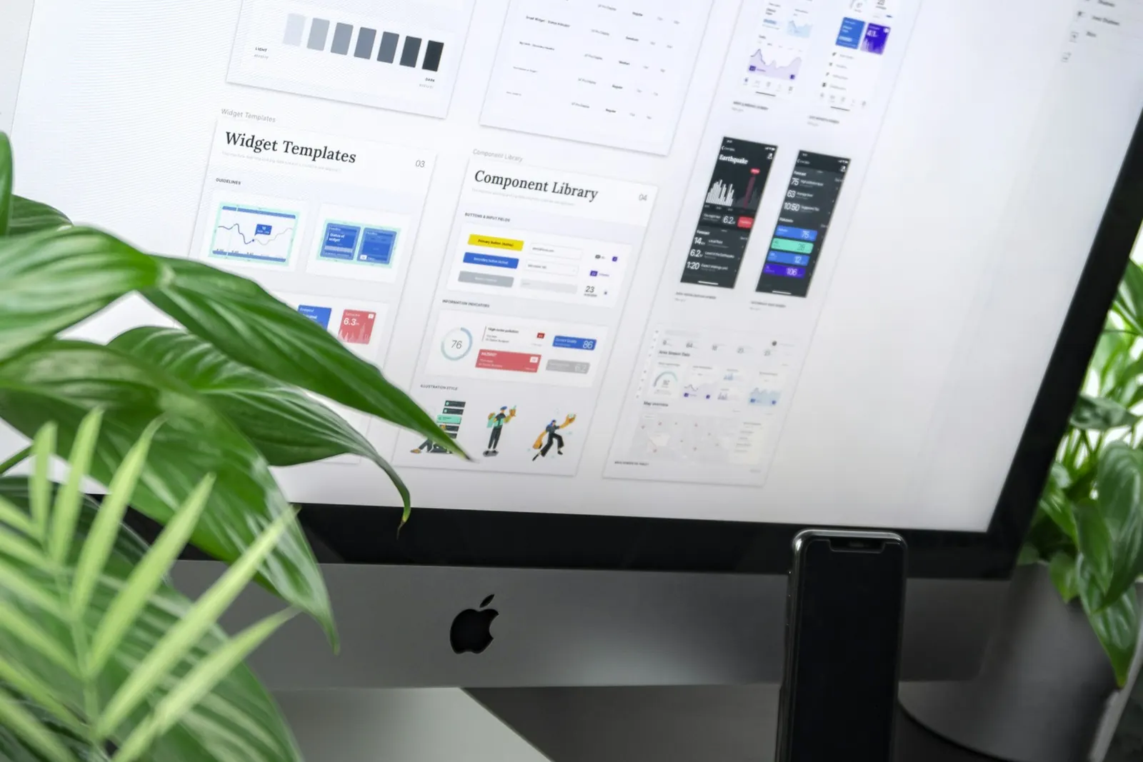 Custom website UI design components on a desktop monitor, Airdrie web design