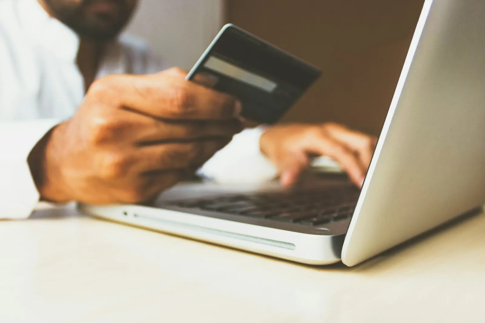Customer paying by card on a laptop through an Airdrie e-commerce website