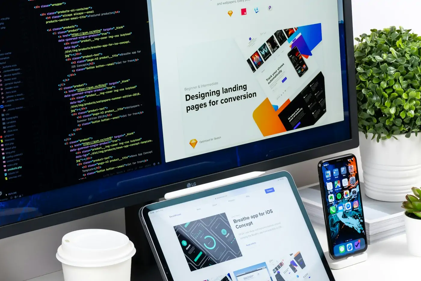 Landing page and event website designs on a monitor, tablet and phone